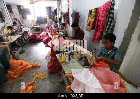 Dhaka 20 march 2014.The number of children working at different tailors’ shops in Keraniganj on the outskirts of the capital in Dhaka .The children, some preteens, works only for tips and get no salaries in small businesses that have no fire safety measures. Stock Photo