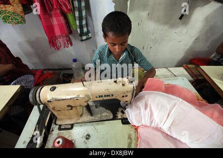 Dhaka 20 march 2014.The number of children working at different tailors’ shops in Keraniganj on the outskirts of the capital in Dhaka .The children, some preteens, works only for tips and get no salaries in small businesses that have no fire safety measures. Stock Photo