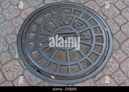 Manhole cover (sewer) in the streets of Boston, Massachusetts, USA Stock Photo