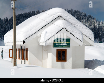 India, Kashmir, Gulmarg, Himalayan Ski Resort, snow covered pay and use public toilet and bath room Stock Photo