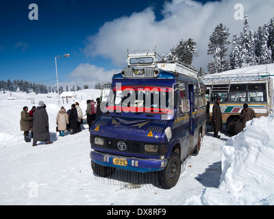 India, Kashmir, Gulmarg, Himalayan Ski Resort main bazaar, local bus to Tangmarg with chains on wheels in snow Stock Photo