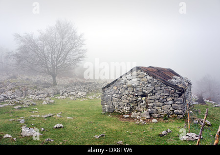 stone shed in the mountain with fog Stock Photo