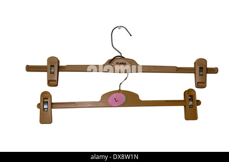 two isolated brown plastic coat hangers with built-in pegs Stock Photo