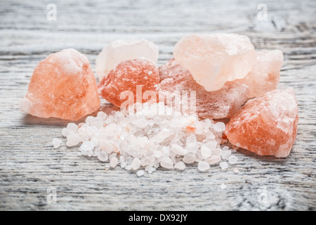 Himalayan pink crystal salt on wooden board Stock Photo