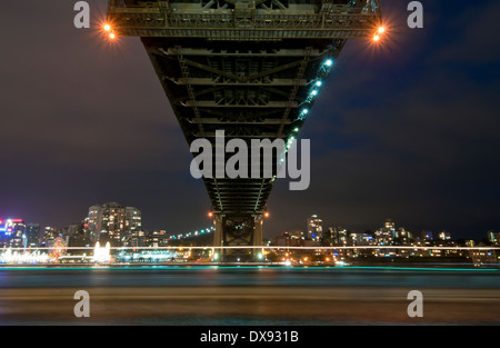 Ferry passing under Sydney harbour bridge Stock Photo
