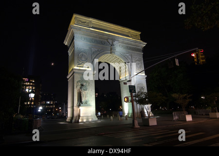 Looking South at the Washington Square Arch illuminated at night seen from the corner of 4th St & 5th Ave in Greenwich Village Stock Photo