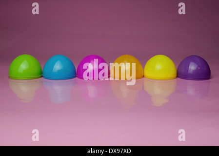 Six Plastic Easter Egg shells on a glossy pink background. cute colorful Easter design Stock Photo