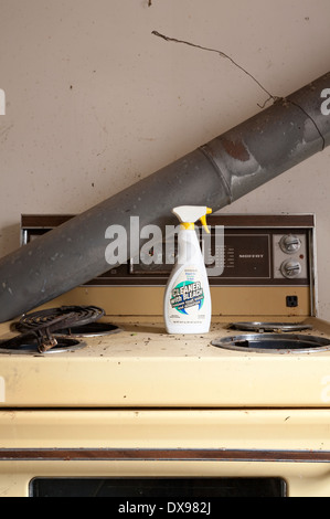 An old dirty and broken stove with a bottle of cleaner sitting on top in the Parry sound District of Northern Ontario, Canada. Stock Photo