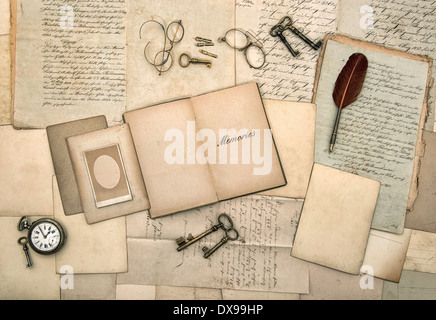 open book, vintage accessories, old letters, post cards, glasses, keys, clock. Stock Photo