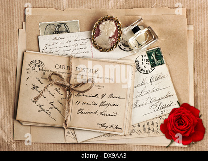 old french post cards, nostalgic accessories and rose flower. vintage sentimental background, Valentine's Day concept Stock Photo