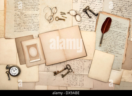 open book, vintage accessories, old letters, post cards, glasses, keys, clock. nostalgic background Stock Photo