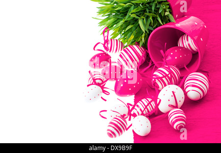colorful white pink painted easter eggs with green grass over table cover. festive composition with space for your text Stock Photo