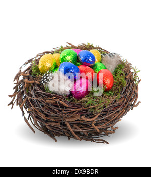 colorful chocolate easter eggs in nest on white background Stock Photo