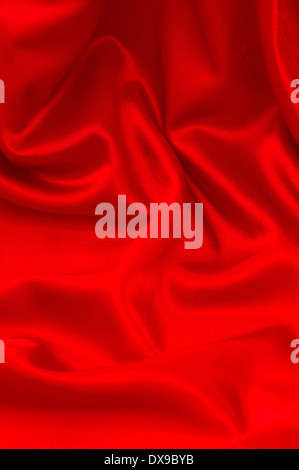 shiny red satin fabric background. silk backdrop Stock Photo