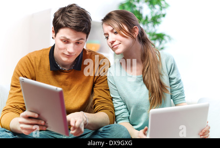 Beautiful young man showing something in his girlfriend on a touchpad Stock Photo
