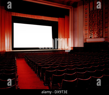 Interior of empty Cinema/Theatre with red velvet seats and red satin curtains, show waiting to start, nobody attending, blank Stock Photo