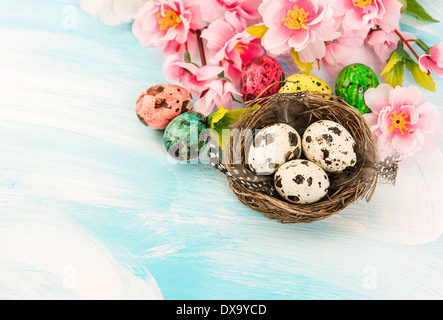 Easter decoration with flowers and eggs in nest. Festive composition Stock Photo