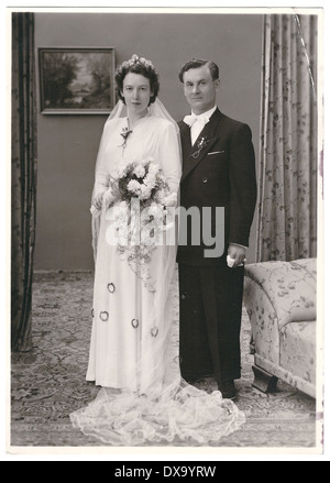 MUNICH, GERMANY - CIRCA 1950: vintage wedding photo. portrait of just married couple. bride and groom wearing vintage clothing. Stock Photo