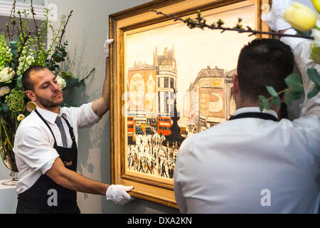 Sotheby's, London, March 21st 2014. Sotheby's workers hang LS Lowry's Piccadilly Circus, painted in 1961 and expected to fetch between £4-6 million at auction on March 25th as the AJ Thompson collection, the most comprehensive of Lowry's work, goes on sale. © Paul Davey/Alamy Live News Stock Photo