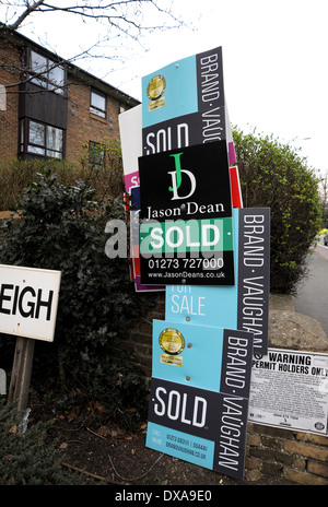 Estate Agents Sold boards outside block of flats in Brighton UK Stock Photo