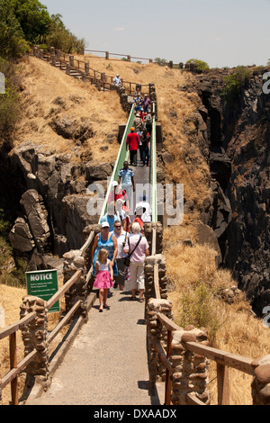 Visitors crossing Knife-edge bridge Victoria Falls Livingstone Zambia Stock Photo