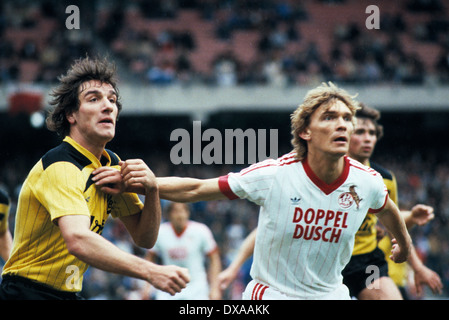 football, Bundesliga, 1983/1984, Muengersdorf Stadium, 1. FC Cologne versus Borussia Dortmund 5:2, scene of the match, Bernd Klotz (BVB) left and Paul Steiner (FCK) Stock Photo