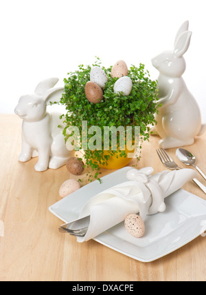 Festive Easter table setting with eggs and flowers on white background ...
