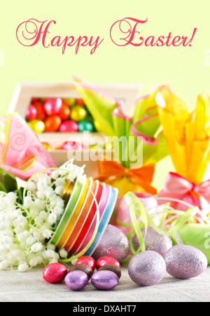 Happy Easter! card concept. colorful easter decoration. chocolate eggs and flowers Stock Photo