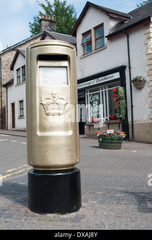 Golden post box in Dunblane painted for Andy Murray winning gold at the Olympics 2012, London. Stock Photo