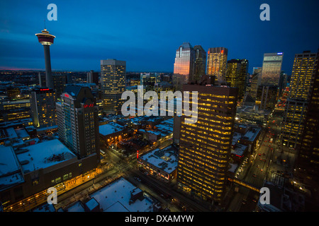 The lights in Calgary's downtown core buildings glow as dawn is reflected in the windows of Bankers Hall. Stock Photo