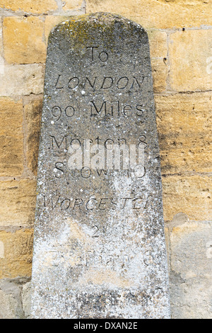 Old weathered stone marker milestone on Thruxton Village green engraved ...