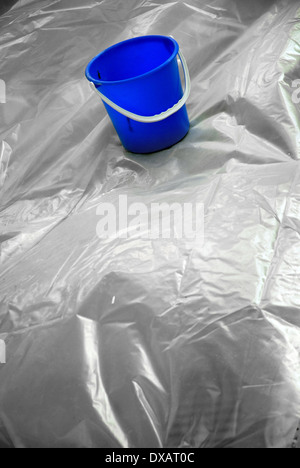 Blue bucket on tarpaulin Stock Photo