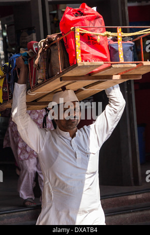 Dabbawala carrying Lunch Dabbas (Tiffin Boxes) for delivery to customers outside Churchgate Railway Station in Mumbai, India Stock Photo