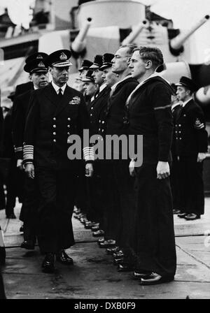 Royal Navy George VI inspects sailors on board a navy battleship during ww2 Stock Photo