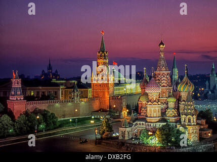 May 1, 1987 - Moscow, Russia - Colorfully iIlluminated at night in honor of May Day, this panoramic view shows the most famous tourist attraction in Moscow, Saint Basil's Cathedral, in right foreground. Behind it, rising from the Kremlin Wall in center is the Savior Clock Tower (Spasskaya Tower), an illuminated red star at its apex. At far left is the Alarm Tower (Nabatnaya Tower). Other Kremlin domes, spires and towers can be seen in background behind the walls. (Credit Image: © Arnold Drapkin/ZUMAPRESS.com) Stock Photo