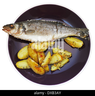 top view of sea bass fish baked in salt and fried potato slices on ceramic plate isolated on white background Stock Photo
