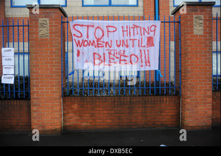 Swinton, Salford, Manchester, UK . 22nd March 2014. Anti-fracking campaigners protest outside Swinton police station, Salford, Manchester. Sign refering to a female anti-fracking campaigner who was bleeding from her head and mouth when arrested by the Tactical Aid Unit on 17th. March. Credit:  Dave Ellison/Alamy Live News Stock Photo