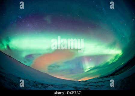 A sky filling Northern Lights (aurora borealis) display over Northern Sweden. High ISO - contains noise. Stock Photo
