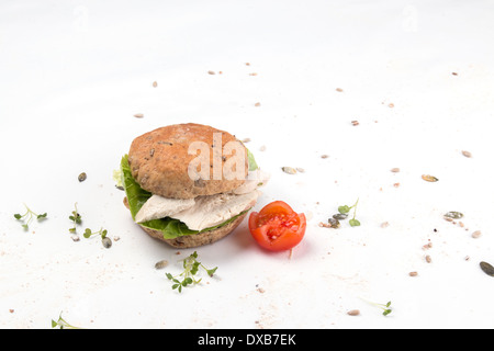 A chicken sandwich made with a seeded granary bread bun/cake/bap  isolated on white with tomato and cress garnish (2 of 5) Stock Photo