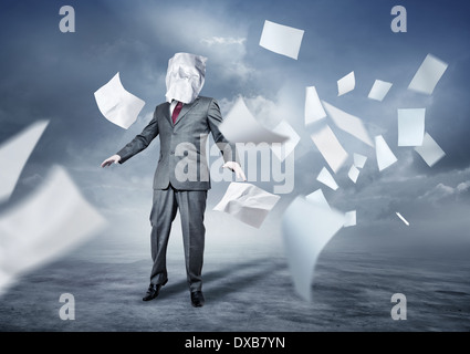 A businessman's face covered in paperwork. Business concept. Stock Photo