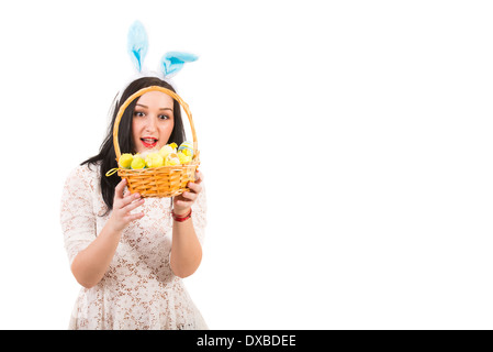 Amazed woman looking into Easter basket with eggs,copy space for text message in right part of image Stock Photo