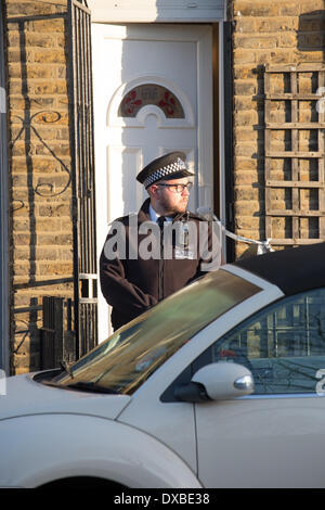 London, UK. 23rd Mar, 2014. Teenage Girl Shot Dead, Hackney, London.   23rd March 2014.  Police standing guard outside the house where the shooting took place.  Police were called to the residence at 1600hrs (GMT) 22nd March 2014 Credit:  Graham Eva/Alamy Live News Stock Photo