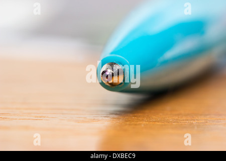 Blue ball pen on a table in macro scale Stock Photo