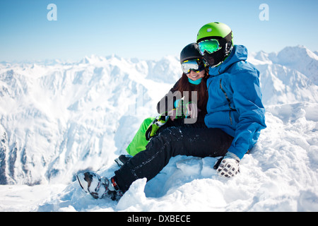 Young happy couple in snowy mountains. Stock Photo