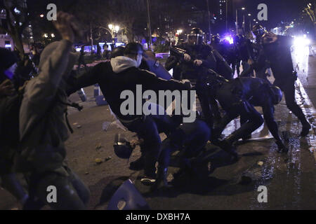 Madrid, Spain. 22nd Mar, 2014. Protestors clash with riot police during a protest called 'March For Dignity' against the government in Madrid, Spain, Saturday. Spanish police and protesters clashed at the end of an anti-austerity demonstration that drew tens of thousands of people to central Madrid on Saturday. Police said in a statement more than 100 people were injured 55 officers some of them with severe wounds and 29 people were arrested. Credit:  Rodrigo Garcia/NurPhoto/ZUMAPRESS.com/Alamy Live News Stock Photo