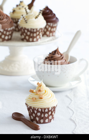 Chocolate fudge cupcakes on a cake stand Stock Photo