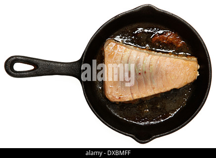 Fresh Oven Baked Sashimi Tuna in cast iron skillet over white. Stock Photo