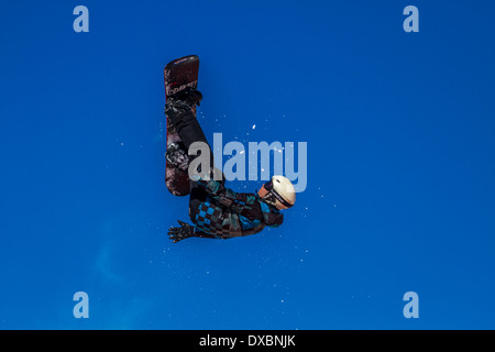 Snowboarder travelling through the air Stock Photo