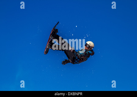 Snowboarder travelling through the air Stock Photo