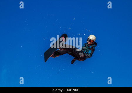 Snowboarder travelling through the air Stock Photo